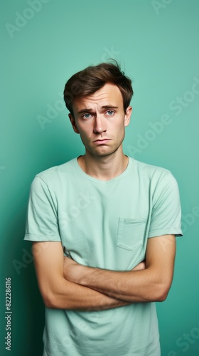 Mint background sad european white man realistic person portrait of young beautiful bad mood expression man Isolated on Background depression anxiety 
