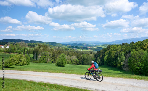 active senior woman on a bike packing tour with her electric mountain bike in the Bavarian Forest near Waldkirchen  Bavaria  Germany 