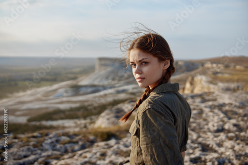 Young woman enjoying breathtaking view of valley from mountain top during travel adventure © SHOTPRIME STUDIO
