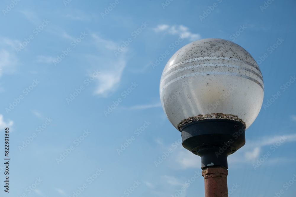 Street white round lighting lantern against the sky. Close-up. Street white round lighting lantern against the sky. Close-up.
