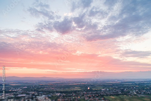 Bird s eye view of the sunset. Below are fields and villages against a dramatic  beautiful sky.