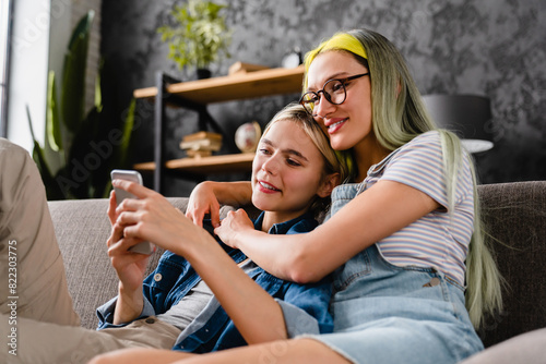 Tableau sur toile Happy passionate young lesbian lgbtq couple hugging cuddling spending time toget
