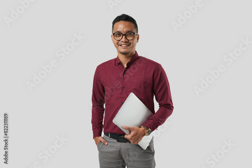 A young handsome Asian man in a suit wearing glasses and making various facial expressions and holding a laptop.
