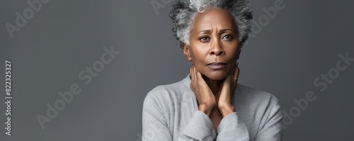 Silver background sad black American independent powerful Woman. Portrait of older mid-aged person beautiful bad mood expression girl Isolated on Background photo