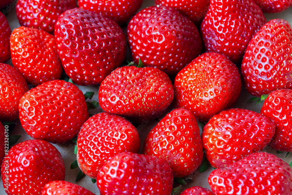 The light reflection on the shiny surfaces suggests the strawberries's freshness The light reflection on the shiny surfaces suggests the strawberries's freshness