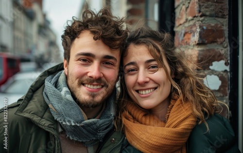 Wrapped in warm autumn attire, a French couple shares a moment of happiness on a lively city street.