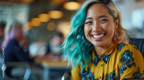 Happy candid female employee with teal hair laughing with colleagues in relaxed office team building  induction meeting. Inclusion & diversity in positive workplace. Celebrating differences  photo
