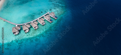 vacations in Maldives, aerial view of beautiful hotel villas on turquoise water beach, luxury resort, banner background with copyspace