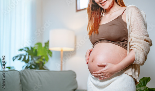 birth, motherhood, child, pregnant, parenting, prenatal, parenthood, pregnancy, mother, life. A woman is pregnant and is holding her stomach. She is wearing a brown top and white pants. Free Download birth, motherhood, child, pregnant, parenting, prenatal, parenthood, pregnancy, mother, life. A woman is pregnant and is holding her stomach. She is wearing a brown top and white pants. - GFXLoad