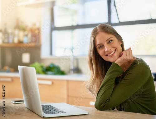 Happy, kitchen and portrait of woman with laptop on table for freelance job, project and networking. Smile, female person and relax with technology at home for remote work, communication and research