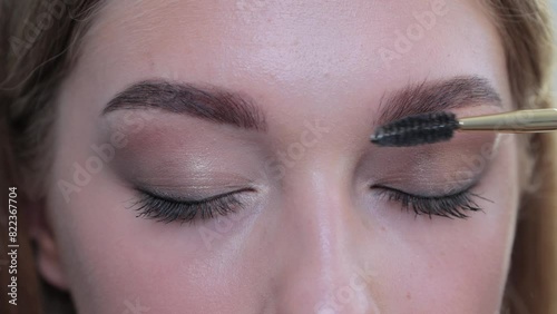 Beautiful woman with long eyelashes, beautiful make-up and thick eyebrows. Professional makeup and cosmetology skin care.