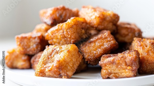 Illustration of golden brown crispy pork pieces against a clean white backdrop