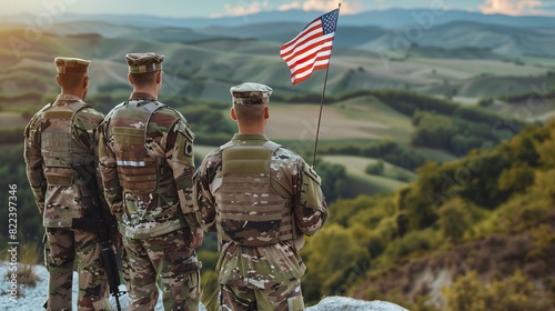 A group of military personnel in uniform holding the American flag during a Flag Day ceremony, with a scenic landscape in the background