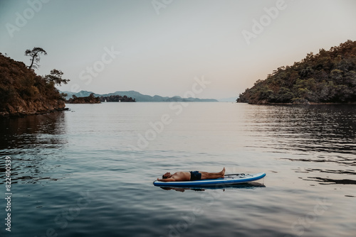 Sportive Guy Resting on the Sup Board