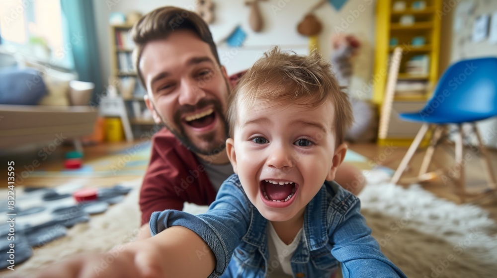 Children room, a boy watches cartoons on a smartphone, and his father is next to him Children room, a boy watches cartoons on a smartphone, and his father is next to him