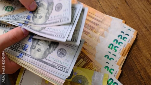 counting dollars on euro banknotes photo
