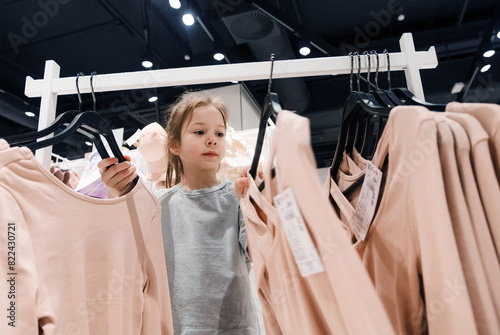 Young Girl Shopping for Clothing in a Store During Daytime