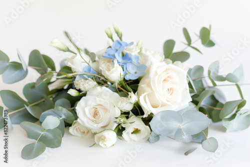 Small bouquet with white and light blue flowers on white background © Venka