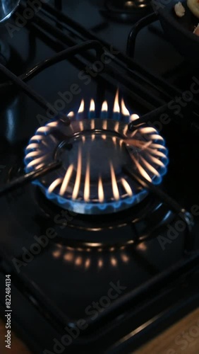The gas is burning. Gas burns on the whip. Kitchen stove. The cooking zone is on. Dangerous gas. Gas burns in the kitchen