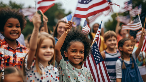 Happy children of different nationalities celebrate 4th of July by energetically waving American flags.