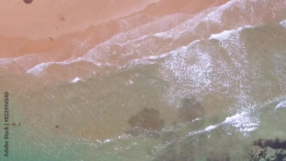 Drone parado filmando de cima ondas azuis quebrando na praia em mares do nordeste brasileiro, em Taipus de Fora, Bahia Drone parado filmando de cima ondas azuis quebrando na praia em mares do nordeste brasileiro, em Taipus de Fora, Bahia