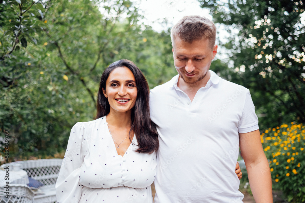 Portrait of young smiling couple in love against backdrop of garden or nature Portrait of young smiling couple in love against backdrop of garden or nature