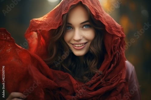 Woman with a captivating smile wrapped in a crimson scarf, exuding charm and warmth