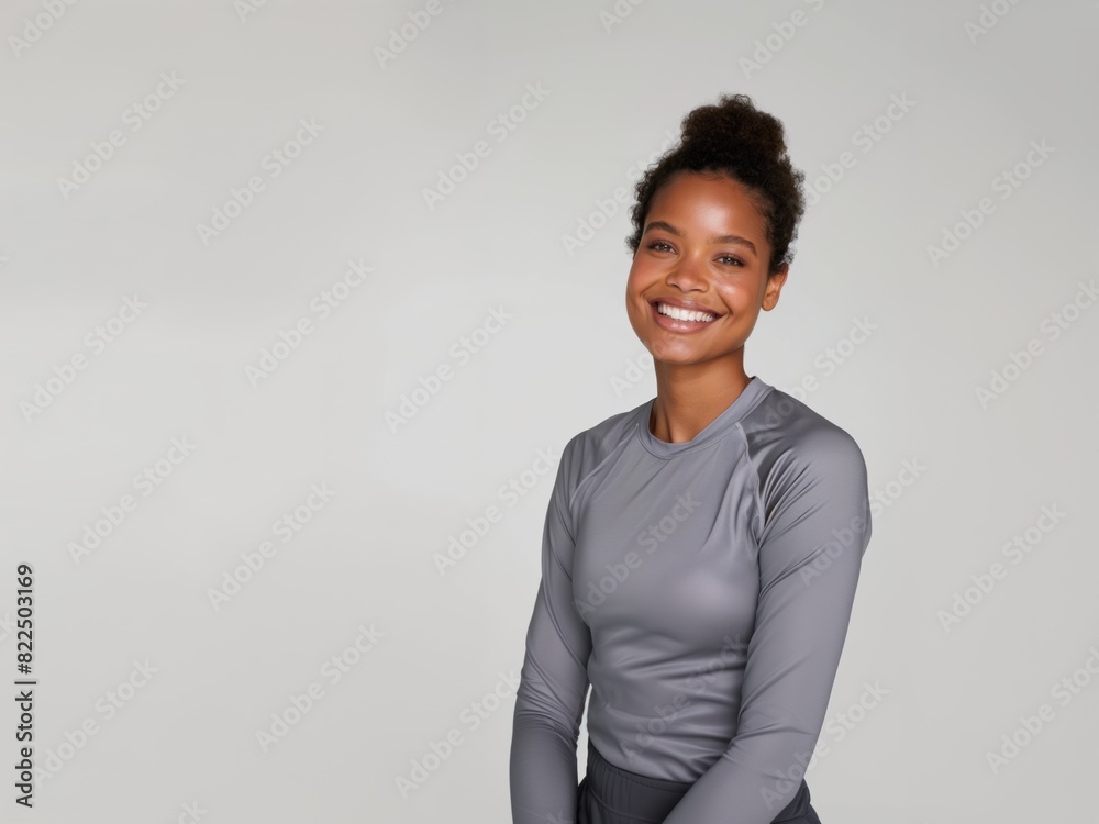 Young slim athletic brunette on a gray background. Active lifestyle, weight loss, motivation. Young slim athletic brunette on a gray background. Active lifestyle, weight loss, motivation.