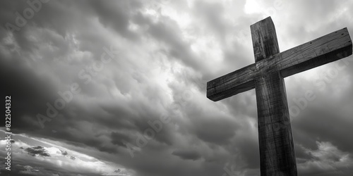 An imposing wooden cross stands against a dramatic, cloud-filled sky, evoking a sense of contemplation