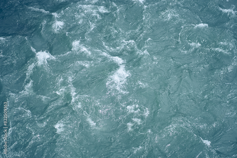 Ripples and waves on the water. Beautiful background with blue water and a place to copy. Close-up of raging water. High quality photo Ripples and waves on the water. Beautiful background with blue water and a place to copy. Close-up of raging water. High quality photo