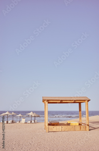 Retro toned photo of a beach with  beach gazebo  sun loungers and umbrellas  Egypt.