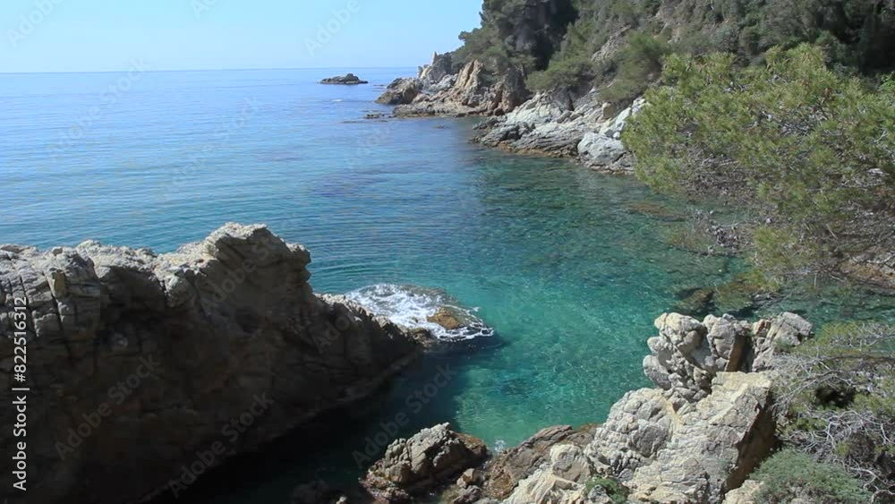Partial view of Treumal beach from a cliff with pine trees. Lloret de Mar, Costa Brava, Girona, Catalonia, Spain. Partial view of Treumal beach from a cliff with pine trees. Lloret de Mar, Costa Brava, Girona, Catalonia, Spain.
