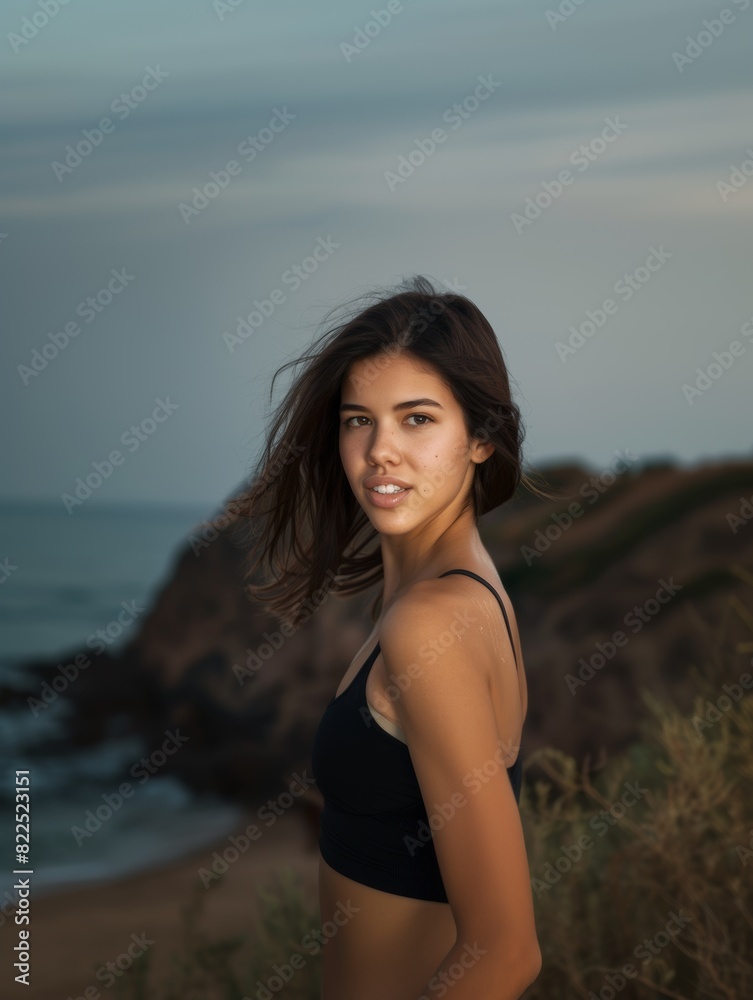 A young brunette woman jogging in nature looks at the camera and smiles. Active lifestyle. Health and beauty. A young brunette woman jogging in nature looks at the camera and smiles. Active lifestyle. Health and beauty.