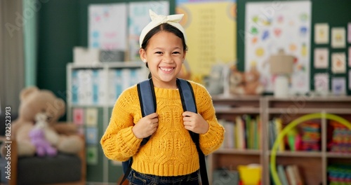 Child, face and smile in classroom with backpack for back to school excited with education, learning or youth. Girl, kid and happiness for first day as elementary student, scholarship or knowledge photo