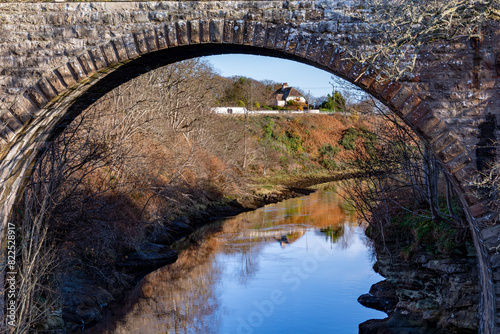 Stone arched bridge over the river in autumn at Brora, Scottish Highlands photo