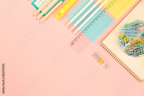 stationery items for girls or women on light pink background. Back to school. Female Student's, pupil's or engineer's supplies. Office objects on pastel pink background. Calculator, pen, pencil etc.