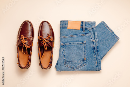 Leather brown moccasins shoes with blue jeans top view, men's casual outfit set, male fashion