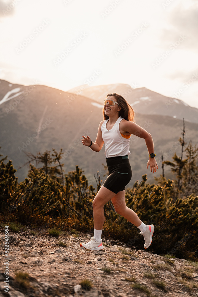 Obraz premium Young traveler Runner girl with backpacks. Hiking in mountains. Tourist traveler. Hiking in Slovakia mountains landscape. Low Tatras national park, Slovakia.