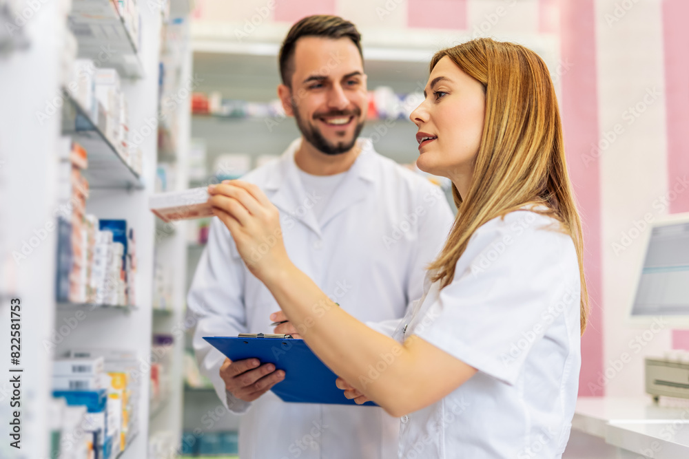 Pharmacists working at the shelfs of pharmacy, drugstore. Pharmacists working at the shelfs of pharmacy, drugstore.