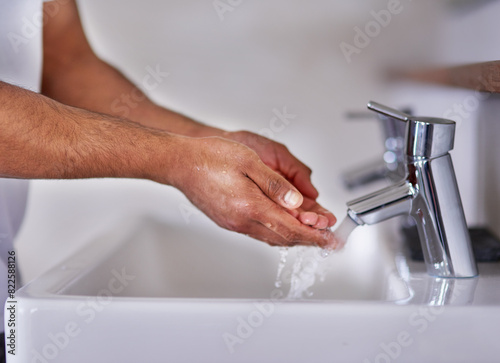 Closeup, water and washing hands in bathroom in home for hygiene, wellness or virus safety in morning routine. Cleaning, liquid and handwashing for skincare, health protection and bacteria prevention