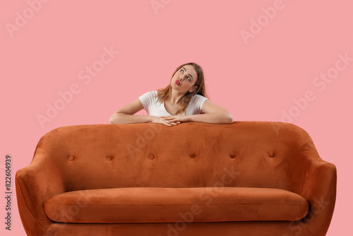 Thoughtful young woman behi...