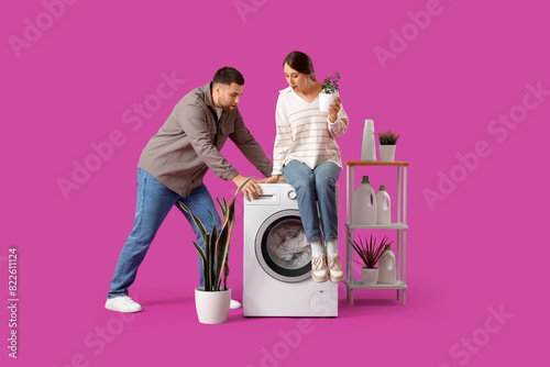 Young couple doing laundry ...