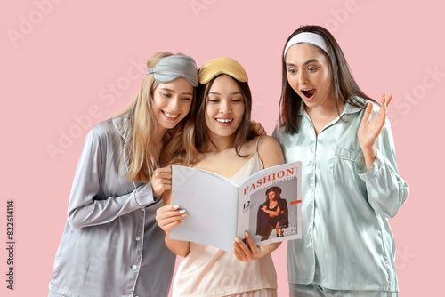 Young women in pajamas read...