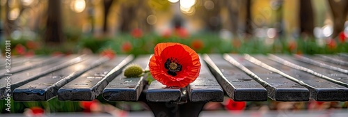 Tribute to fallen heroes  close up of red poppy resting reverently on war memorial photo