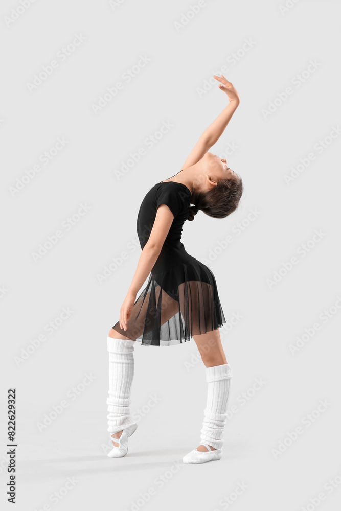 Little girl doing gymnastics on light background Little girl doing gymnastics on light background