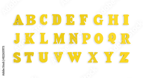 wooden letters of the English alphabet in yellow color on a isolated background close-up