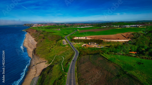 Aerial view of coastal road and green fields in Sandsend, Yorkshire photo