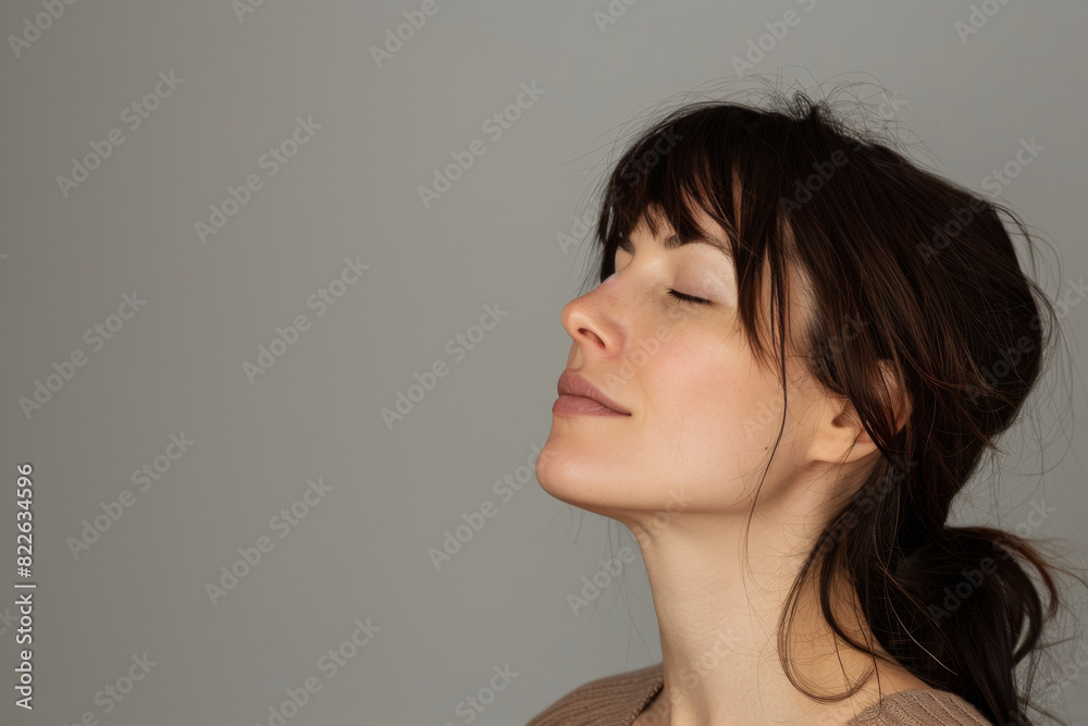 A close up of a woman 's face with her eyes closed
