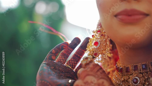 A Shot of an Indian Bride showing her Bridal Jewellery at her Indian Wedding in India