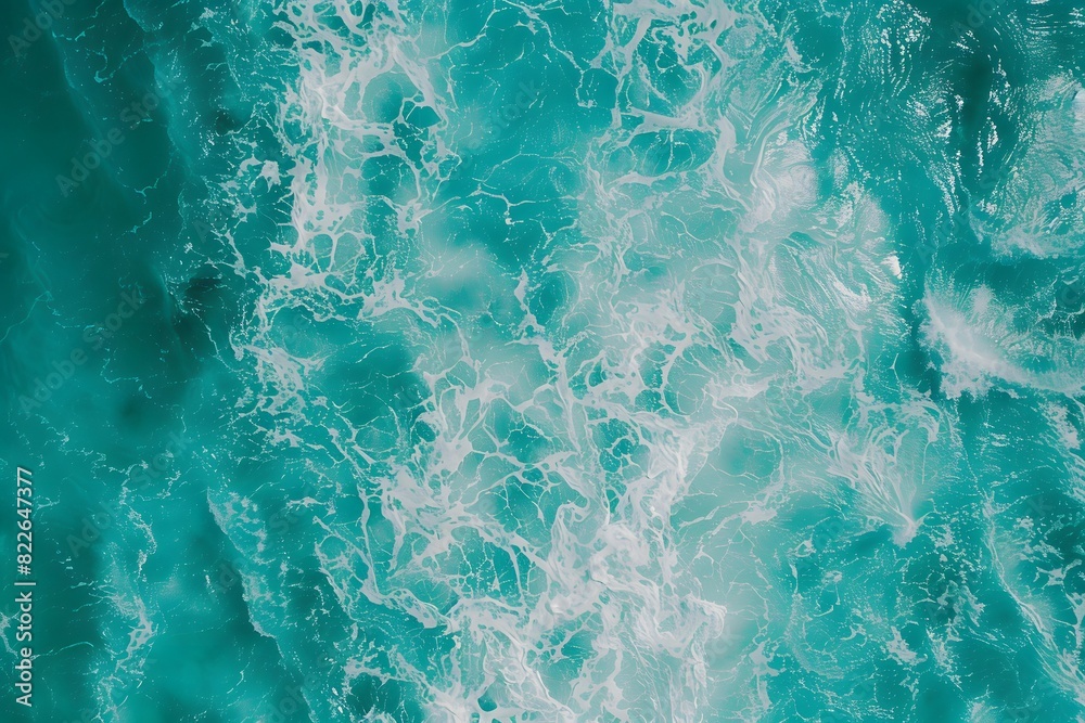Top view of turquoise sea water texture with waves and splashes